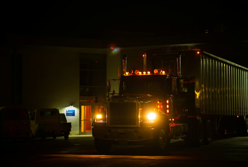 Semi truck with headlights and marker lights on at night